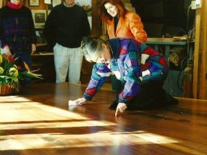 Mira Nakashima polishing the Sacred Peace Table with Miriam Belov in background