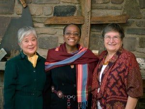 Mira Nakashima, Naomi Tutu, and Irene Goldman at the Nakashima Foundation for Peace Arts Building in front of George Nakashima’s Sanskrit name, “Sundarananda” carved on a cross by Nakashima’s grandson Satoru Amagasu.