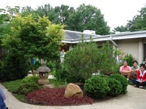 Mira Nakashima preparing to lead a Song for Peace, with Fred Veith in the background.
