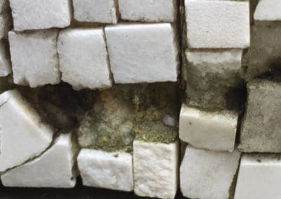 Ben Shahn mosaic damage. Fallen tesserae were re-attached with industrial caulk of poor adhesive quality.